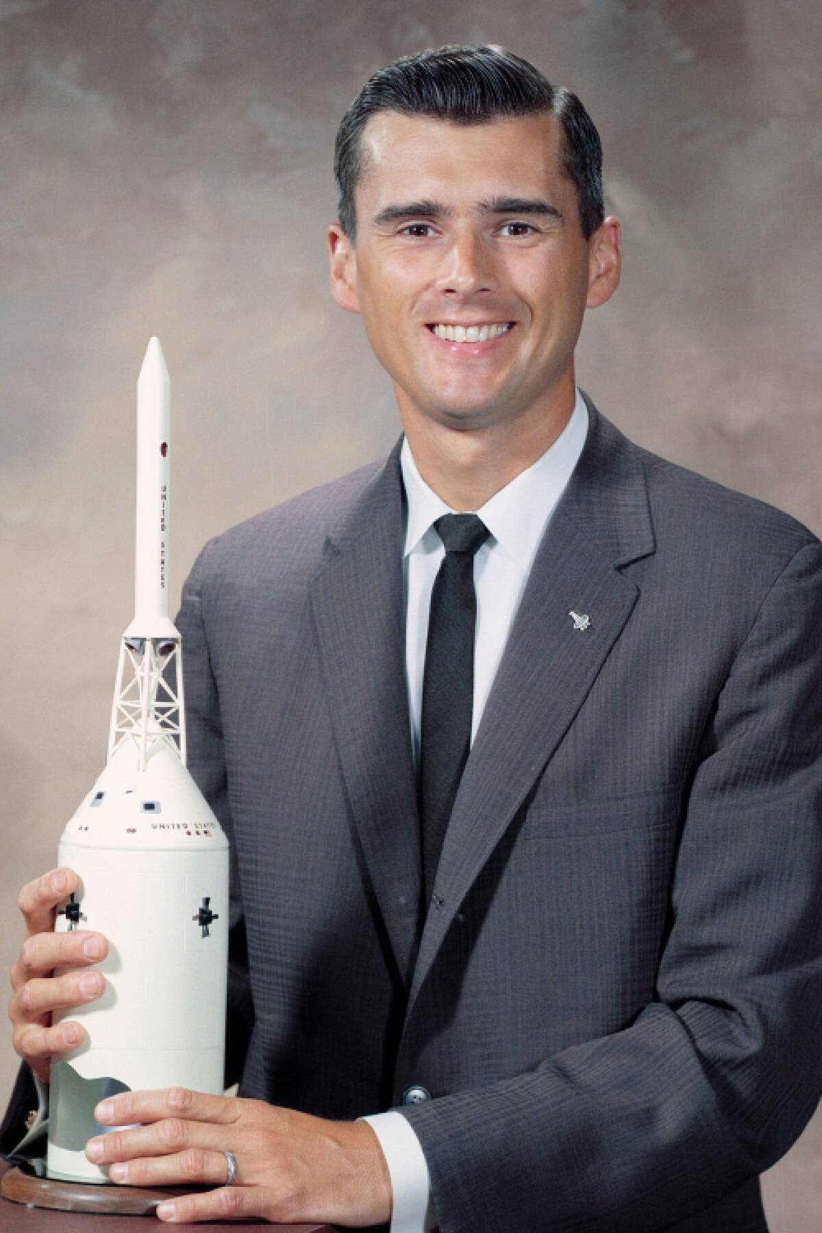 Roger B Chaffee holding a rocket